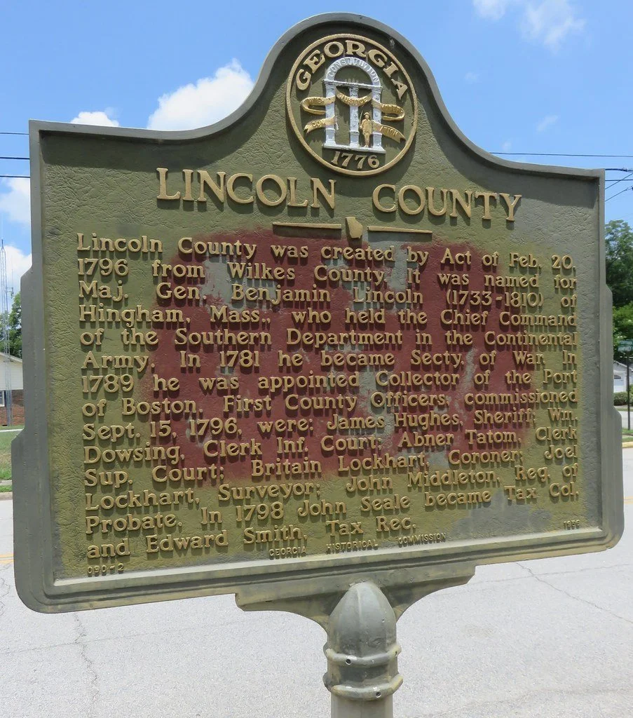 Historical marker for Lincoln County, Georgia, detailing its creation in 1796 from Wilkes County, named after Maj. Gen. Benjamin Lincoln, and early officials including sheriff James Hughes and clerk Abner Tatom.