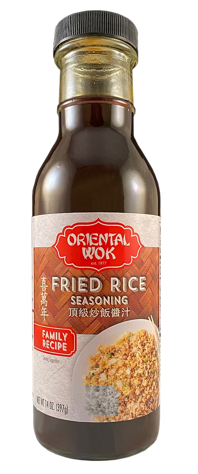 A bottle of Oriental Wok Fried Rice Seasoning with a black screw cap and a white label. The label features the brand name in red, an image of fried rice, and text indicating it is a family recipe.