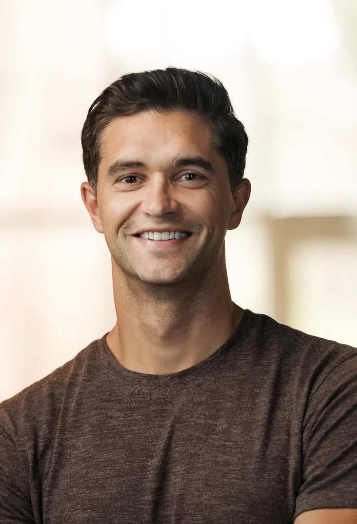 Real Estate agent Trent Meacham standing in front of a bright, blurred background.