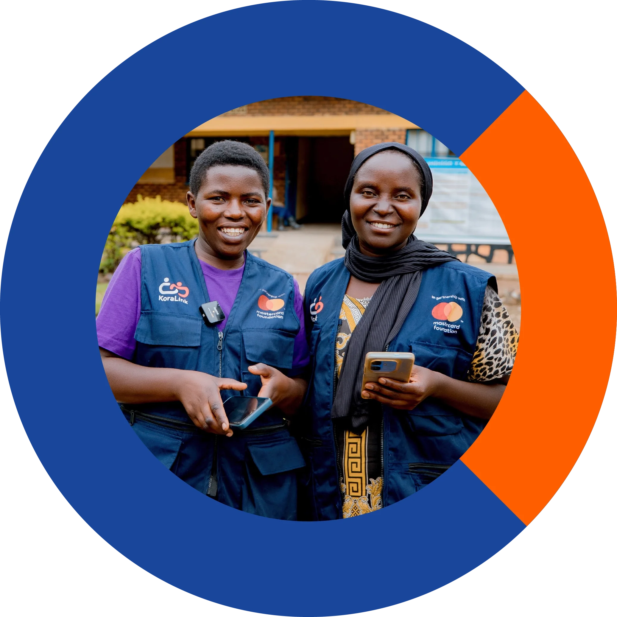 2 young African women wearing KoraLink agent vests holding smartphones