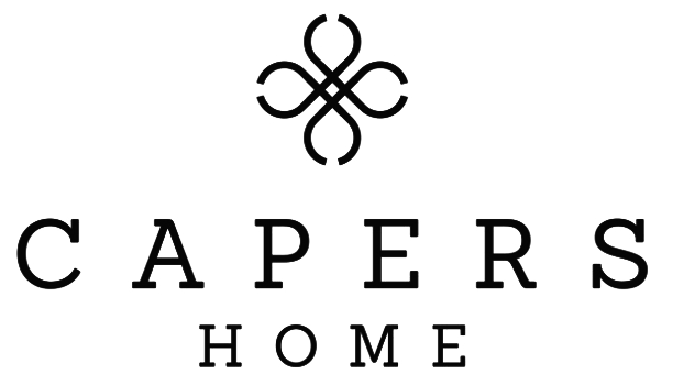 Logo for Capers Home, featuring a decorative symbol above the text.