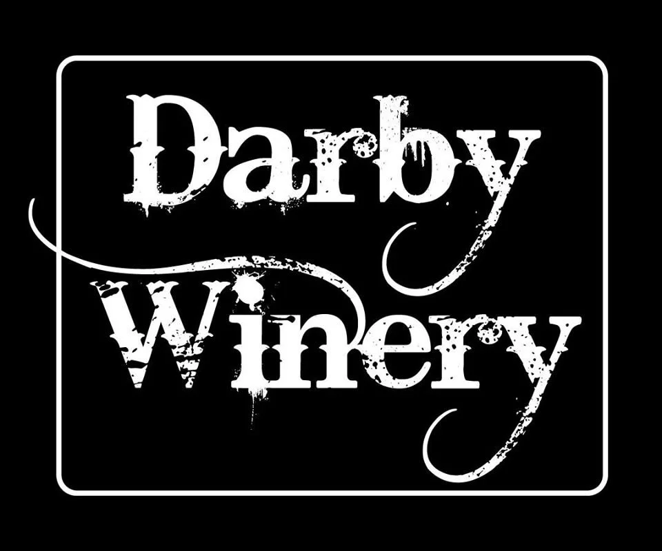 Darby Winery logo in distressed white lettering, an independently owned winery and tasting room in the West Seattle Junction