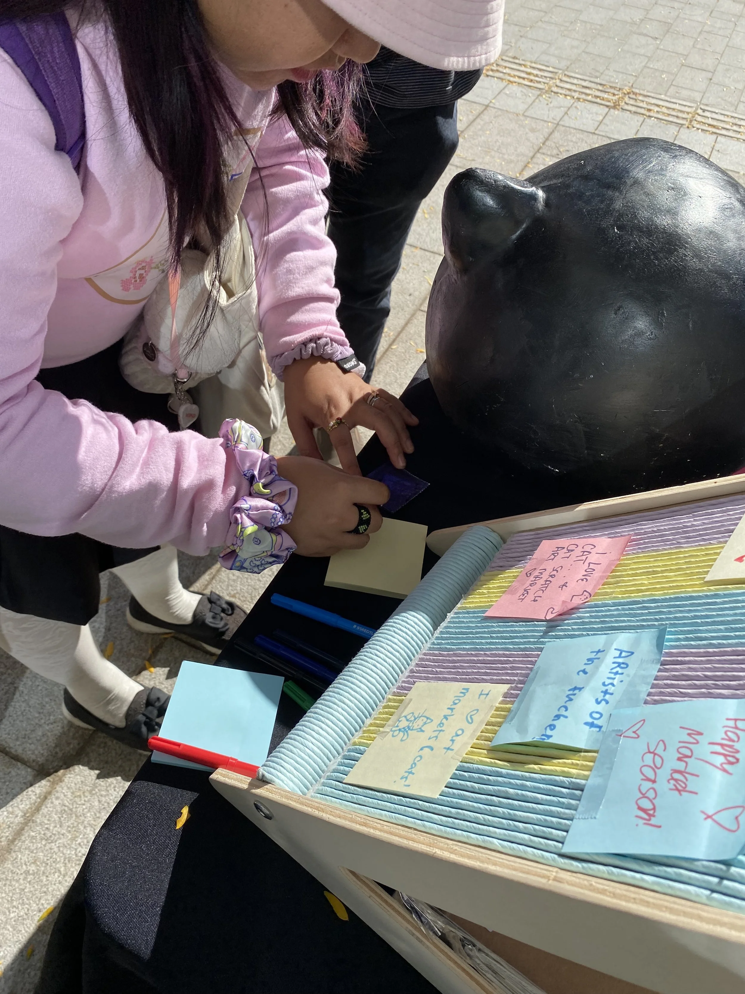  A Cat Scratch visitor filling out their review for the chance to win a prize! (Photo by Joy San) 