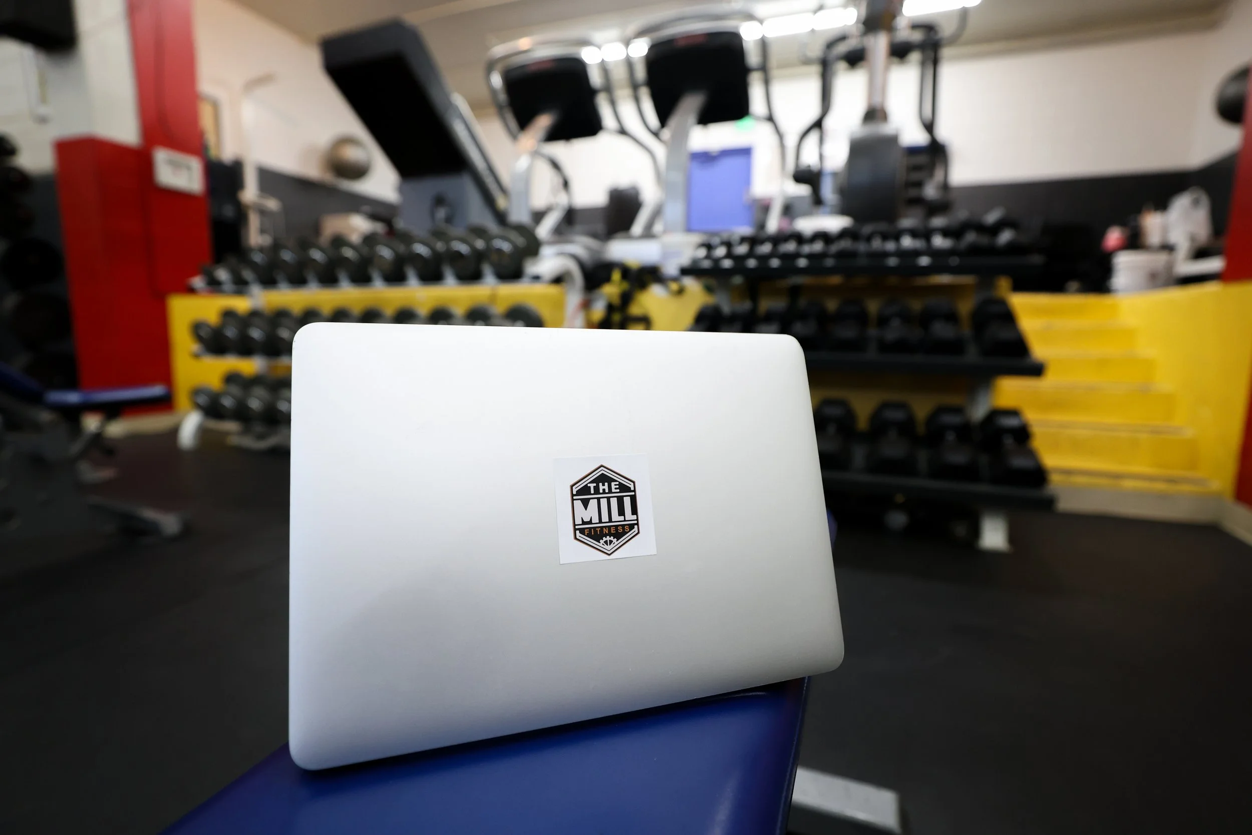 laptop in a gym representing online programming