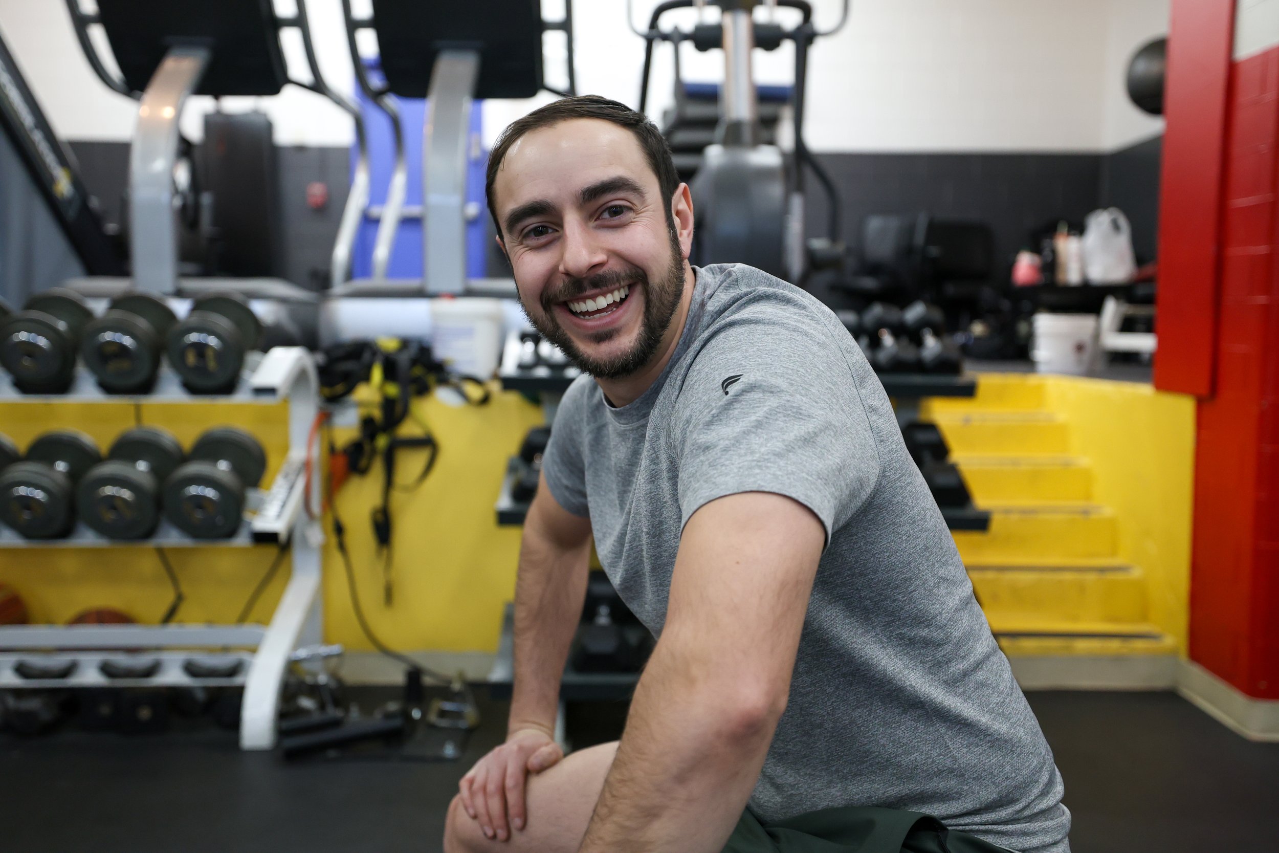 Coach headshot smiling in the gym.