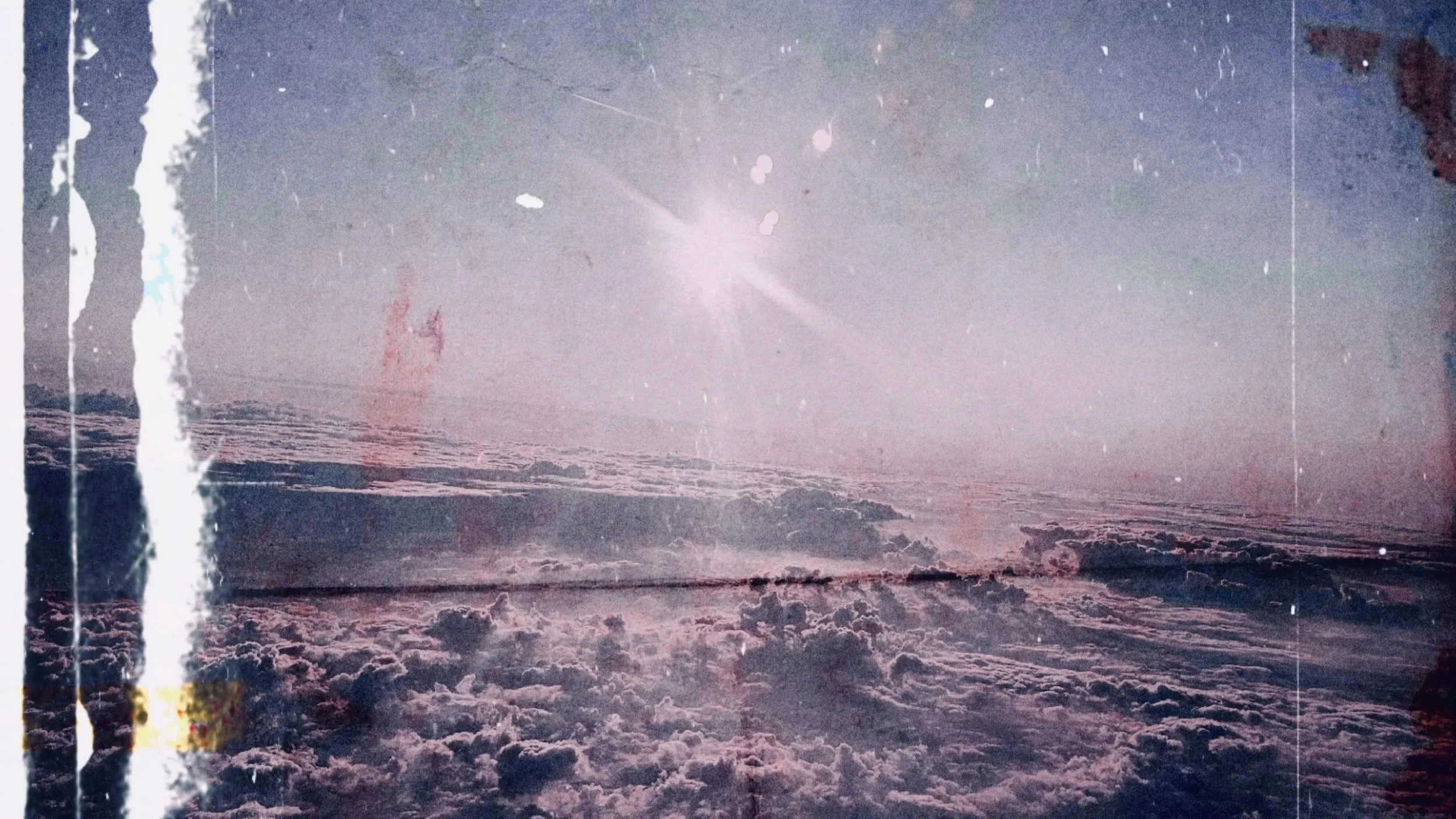A soft, ethereal abstract background showing clouds in light purple, blending into a brighter center with the sun shining above the clouds, within a black frame and dust effects.