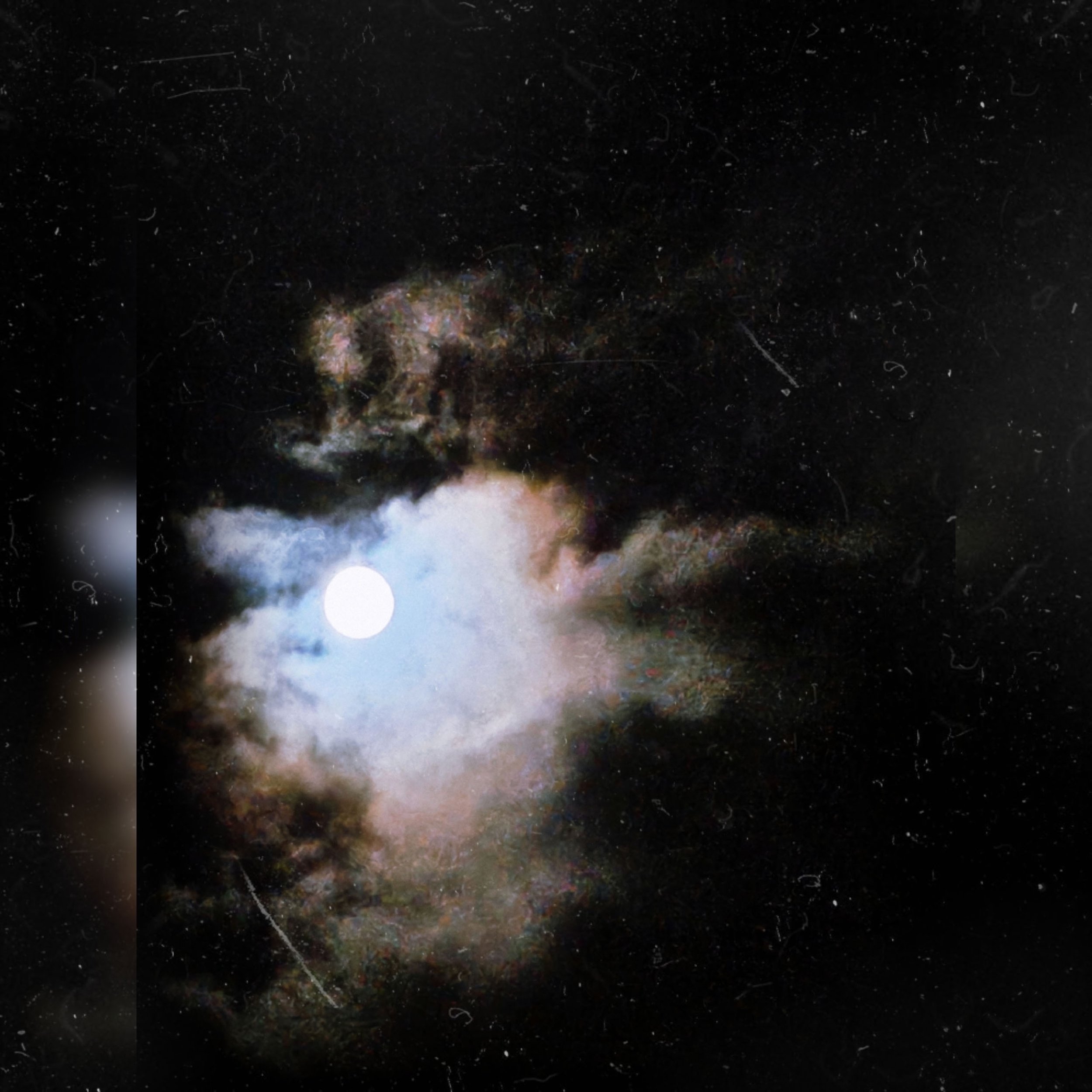 A textured photograph of a glowing full moon surrounded by colorful, hazy clouds against a dark night sky, styled with vintage dust effects.
