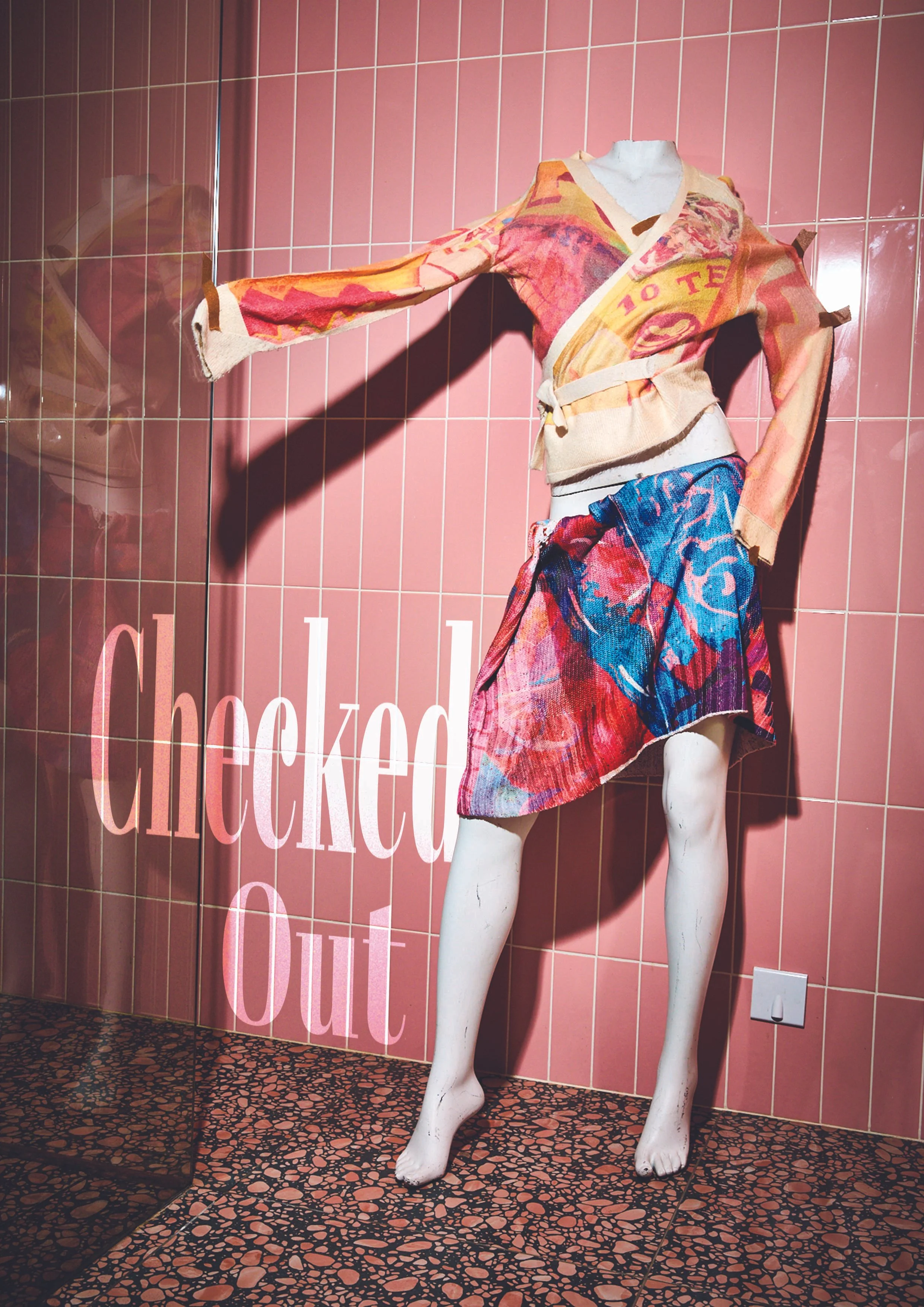 a mannequin dressed in sustainable recycled cardigan and skirt printed with artwork. The background is pink tiles