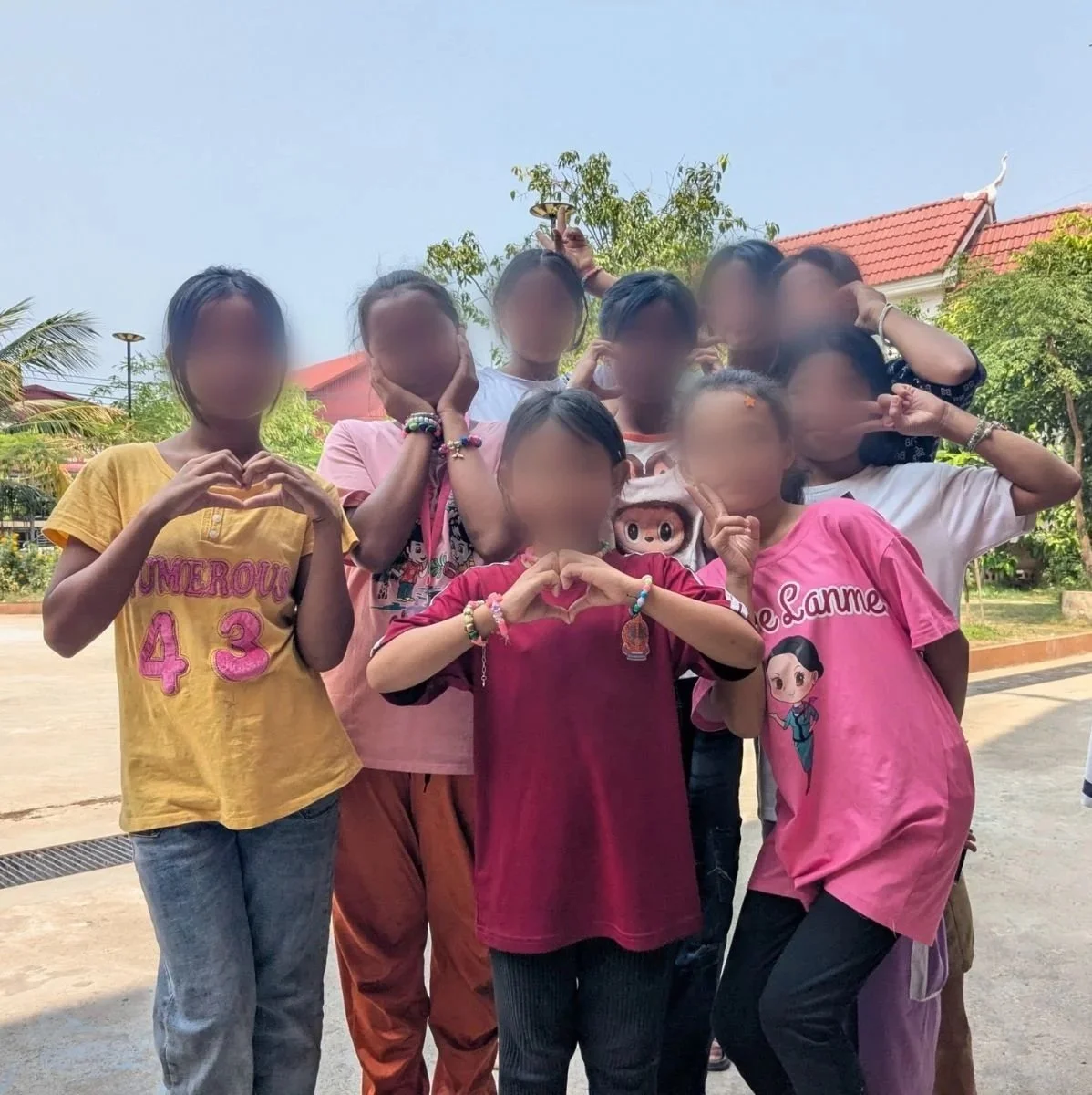 group of girls making the heart sign
