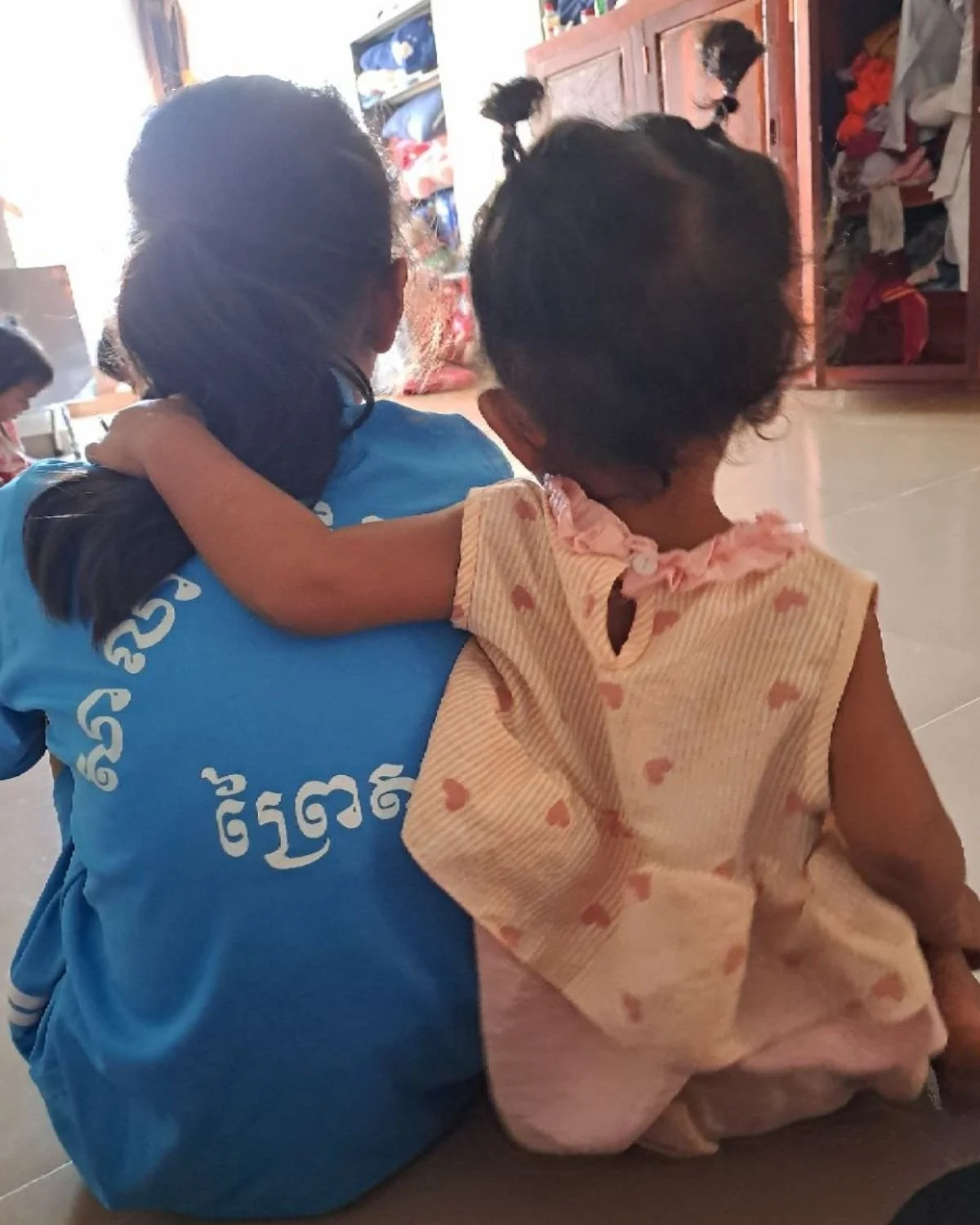 two young heart daughters hugging