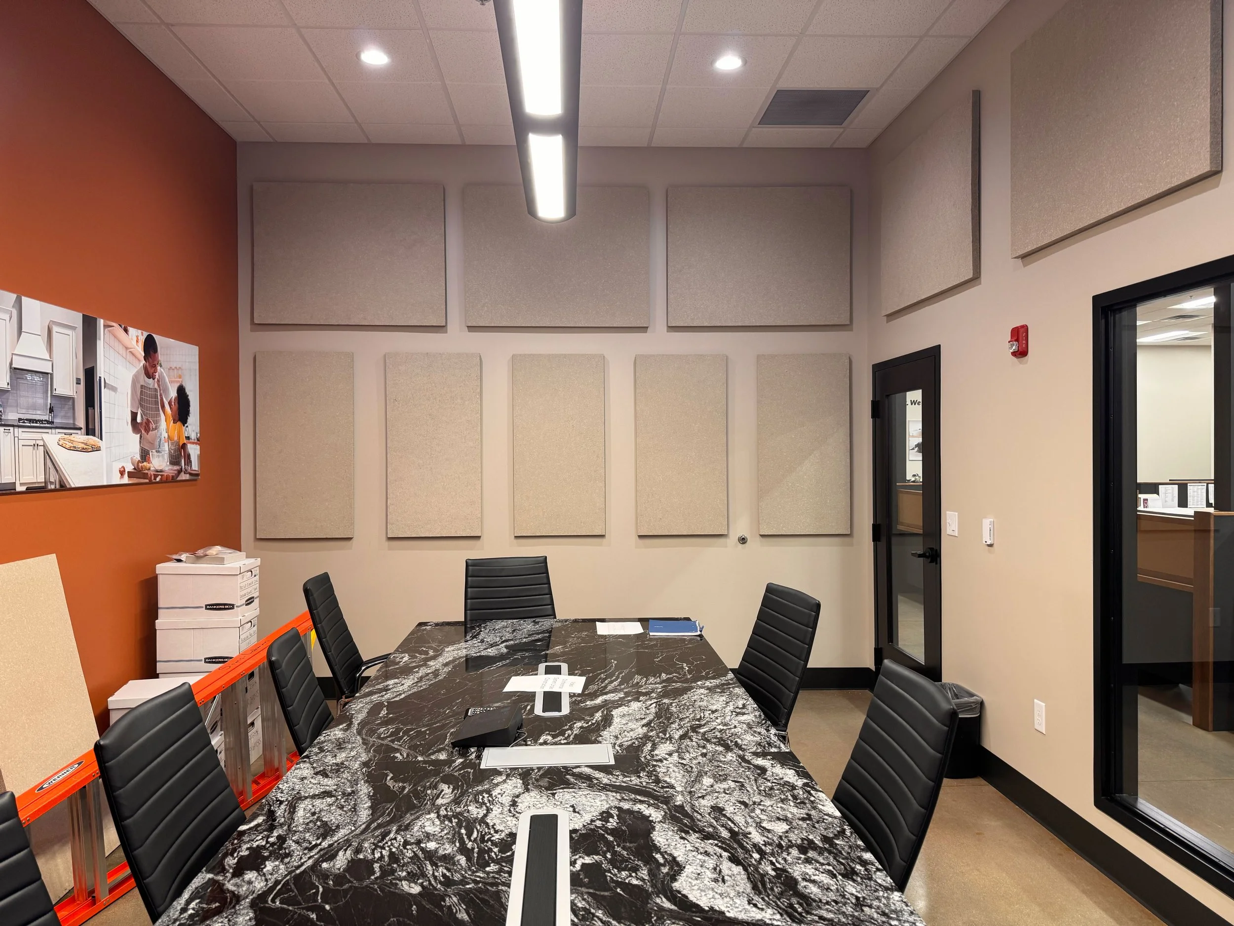 A conference room with a pattern of beige acoustic panels.