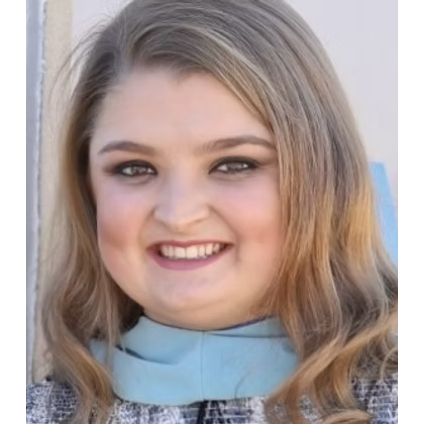 Sarah of Huntsville Behavior Associates with wavy blonde hair, wearing a light blue top and smiling for a professional headshot.