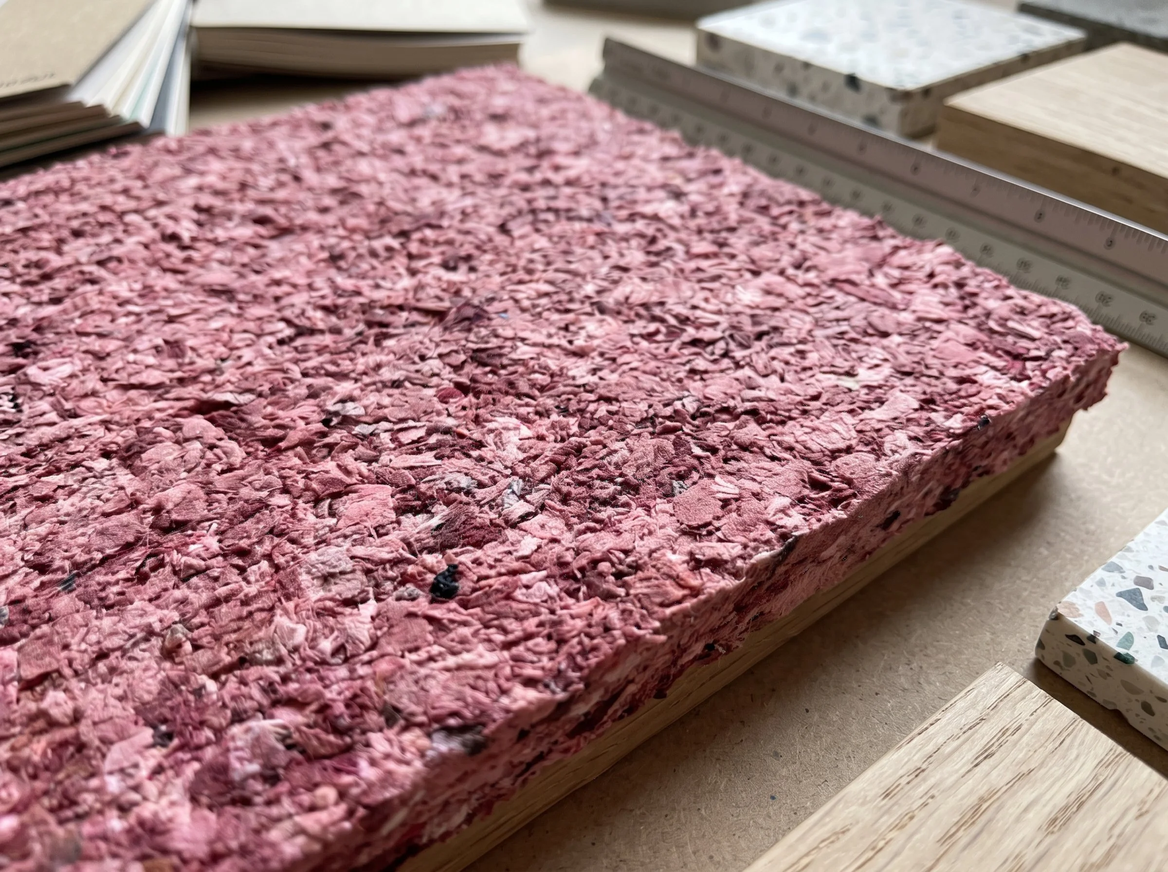 Close-up of a sample of pink, colorful textured wall material that can be used for wall interiors.