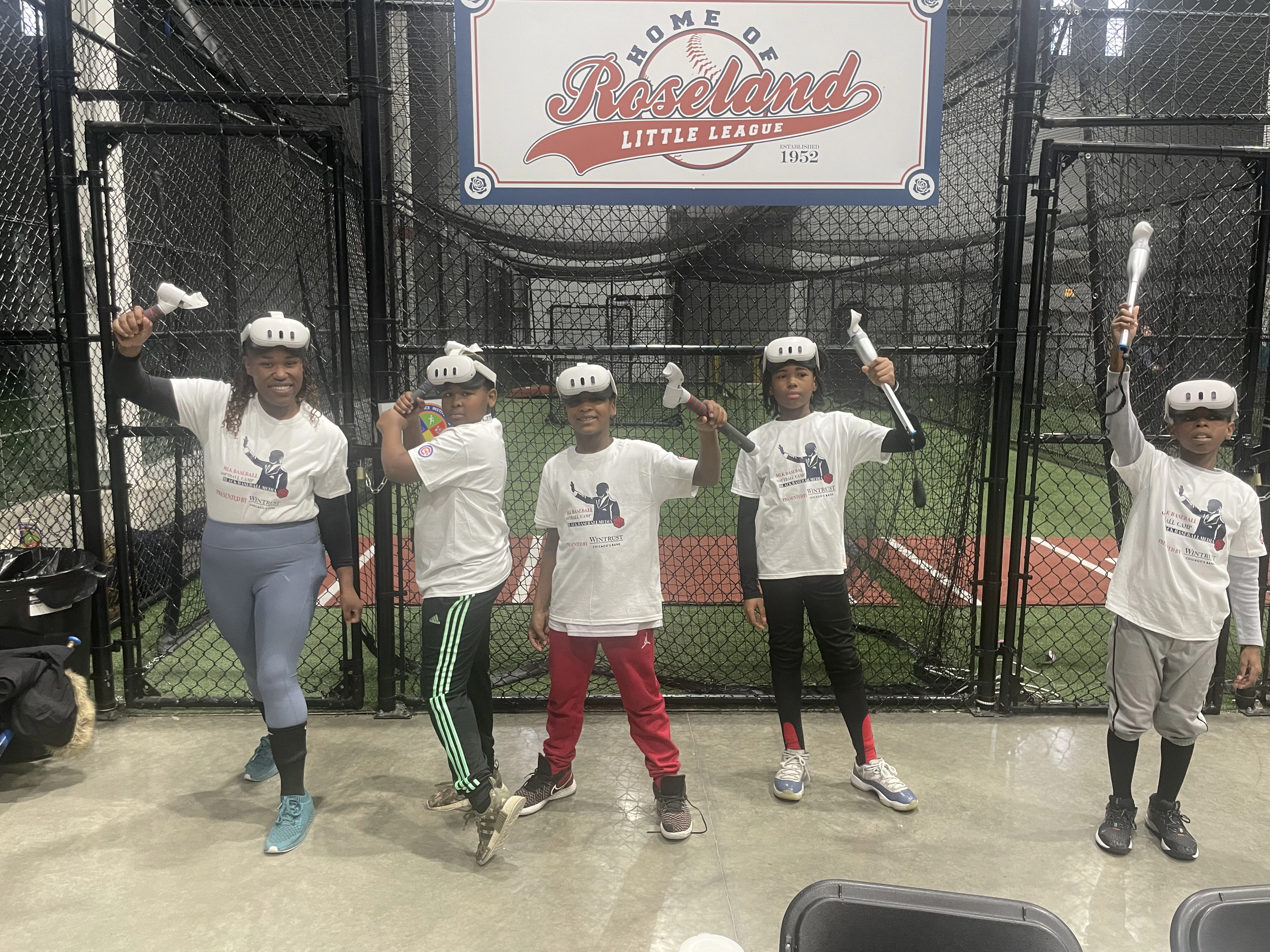 Five kids in VR holding bats at Roseland Little League facility.