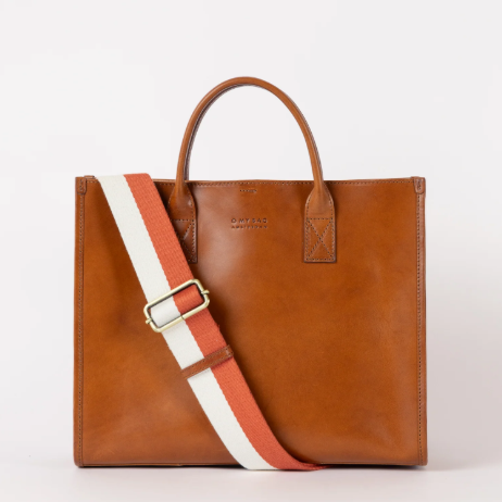 Brown leather tote bag with a striped fabric shoulder strap in red, white, and beige, set against a plain white background.