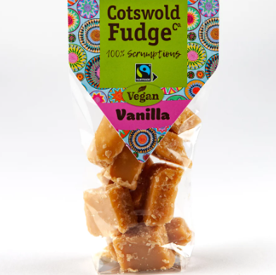 Bag of vegan vanilla fudge candies from Cotswold Fudge Co. with colorful label and clear packaging showing caramel-colored fudge pieces.