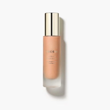 A bottle of liquid foundation with a gold cap on a white background.