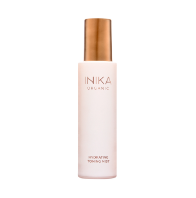 A bottle of INIKA Organic Hydrating Toning Mist with a white label and a gold cap.