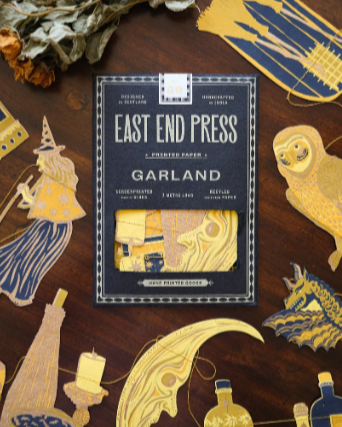 East End Press greeting cards featuring whimsical, fairy tale-themed illustrations like a girl with a party hat, a unicorn, a dragon, and a moon, displayed on a wooden surface along with dried flowers.
