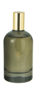 A glass bottle with a gold cap, likely a perfume or cologne container, in a muted green color.