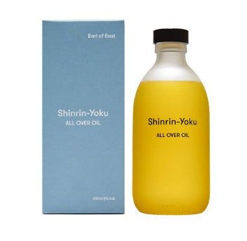 Shinrin-Yoku all over oil bottle next to its blue packaging box.