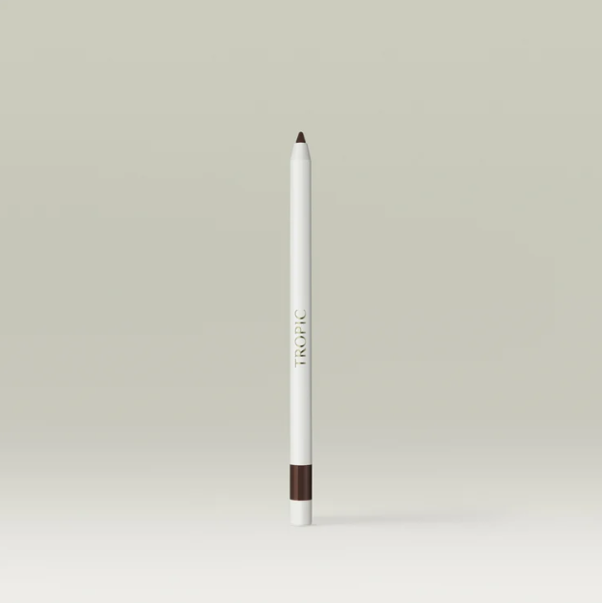 A white makeup pencil with a black tip and a brown band near the bottom, standing upright against a light gray background, labeled 'TROPI C'.