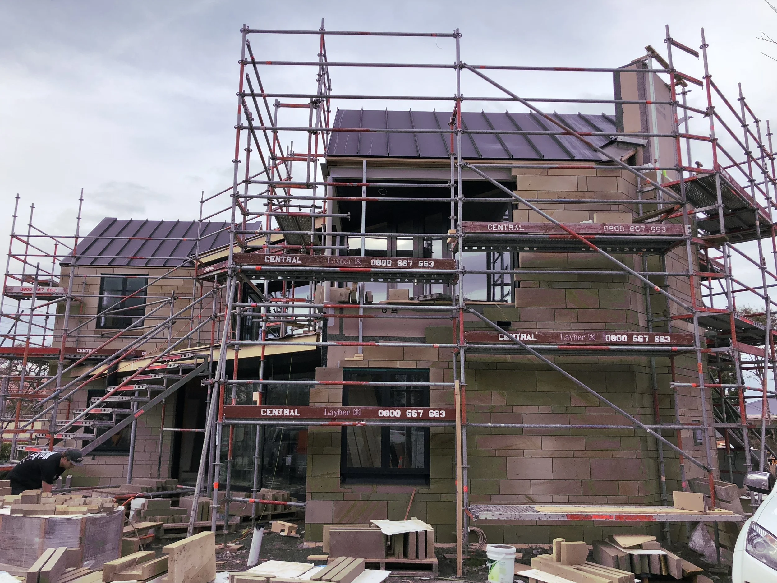 building under construction surrounded by scaffolding