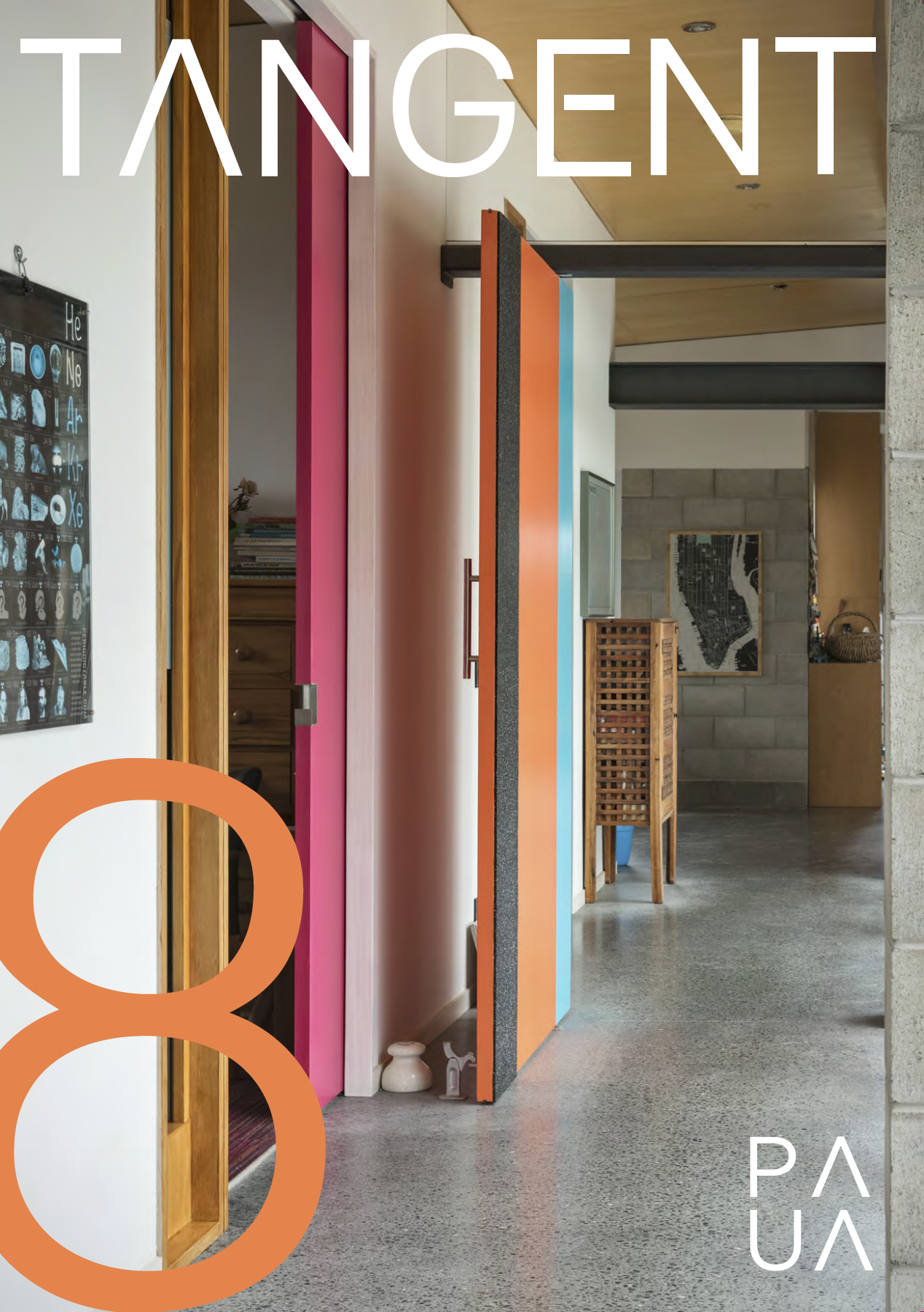 Interior of a modern building with a colorful acrylic divider, wooden furnishings, and artwork on exposed concrete walls.