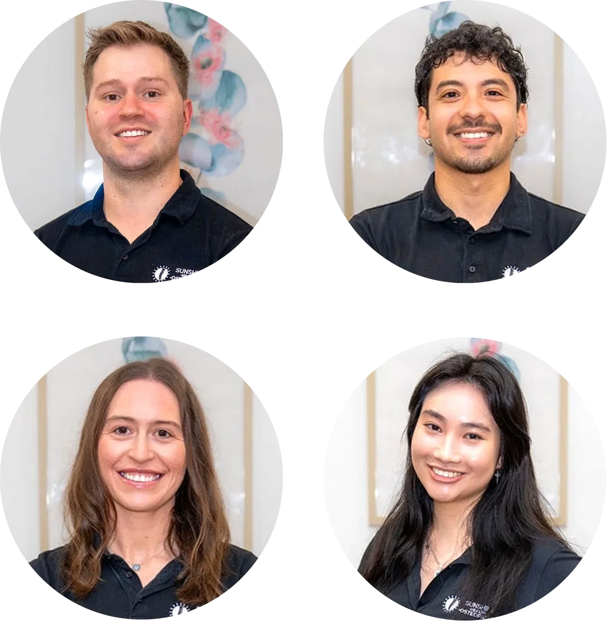 Four individuals, two men and two women, smiling and wearing black shirts with a logo, standing in front of a light-colored wall with floral decorations.