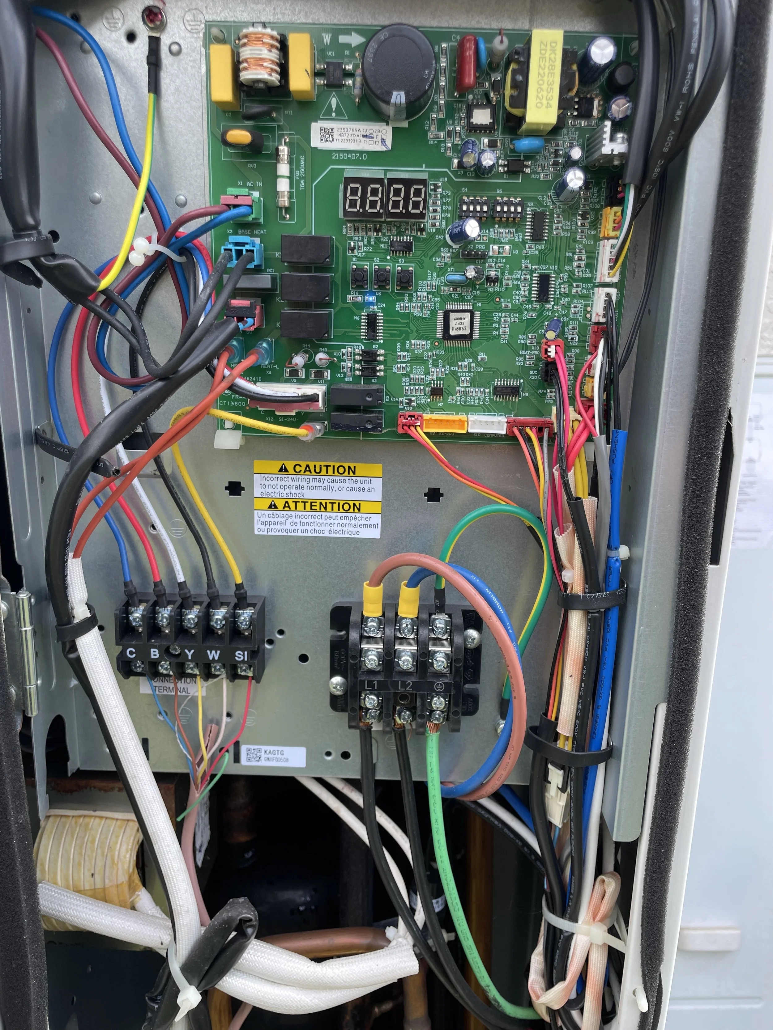 High Efficiency  HVAC service panel with high voltage and control wires, circuit boards, and components inside an enclosure.