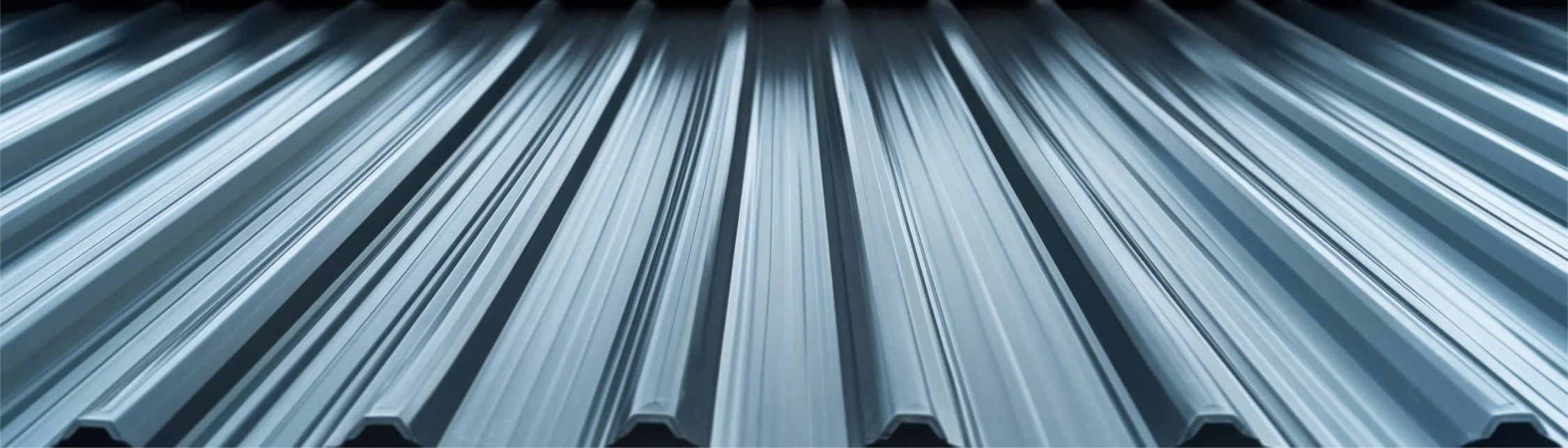 Close-up view of metallic aluminum extrusions arranged in parallel.