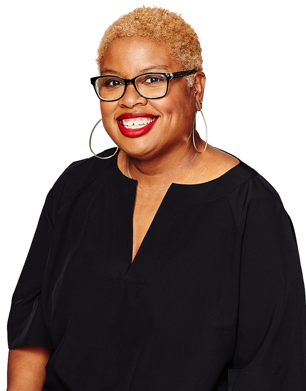 A woman with blonde short curly hair, wearing glasses, large hoop earrings, red lipstick, and a black top, smiling against a black background.