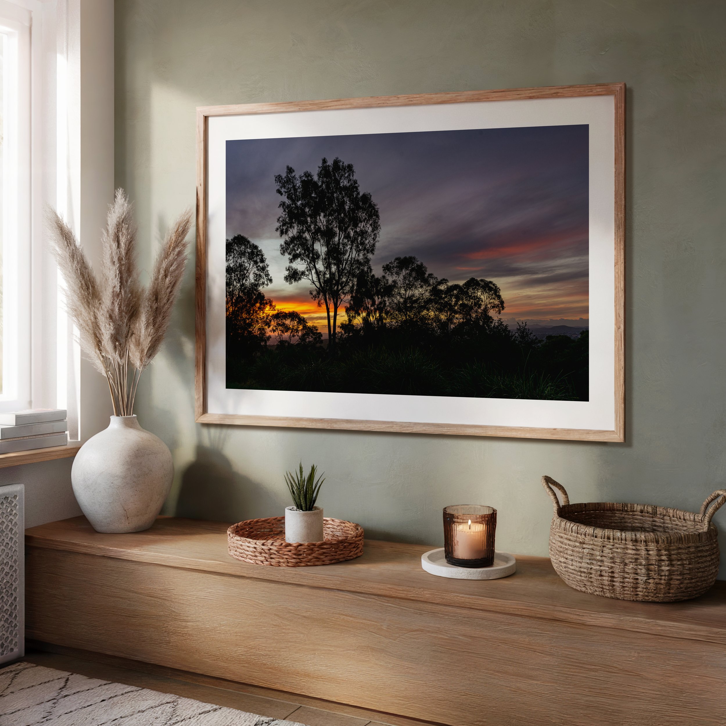 Framed Brisbane sunset photograph displayed in a living room setting