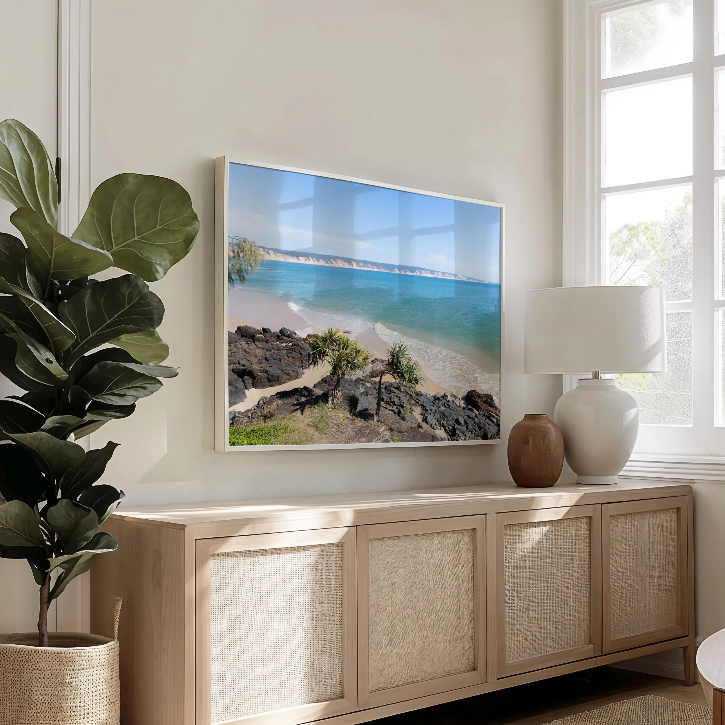 Framed Double Island Point coastal photograph displayed in a living room setting