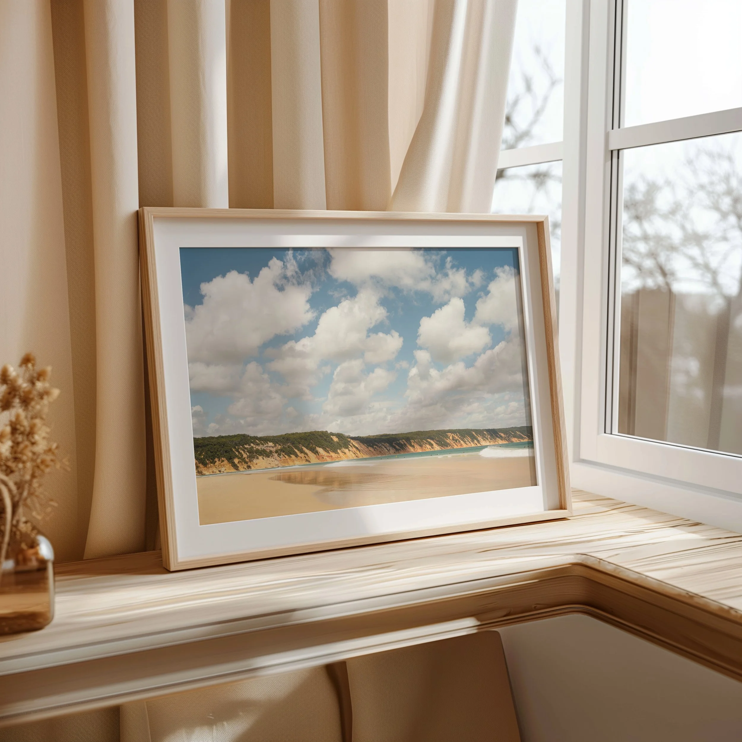 Coastal cliff landscape print styled as wall art in a modern interior