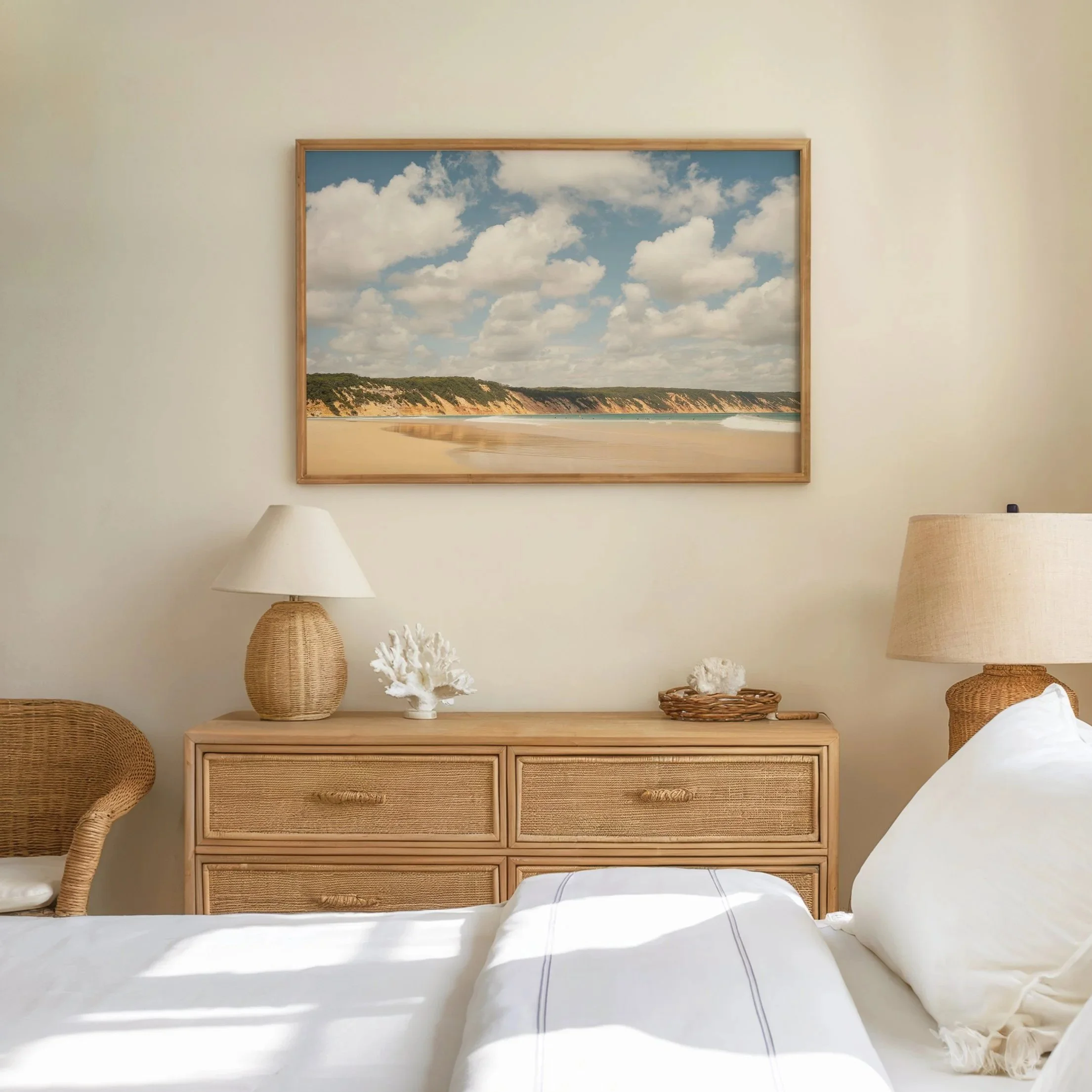 Framed coloured‑sand cliff photograph displayed in a bedroom setting