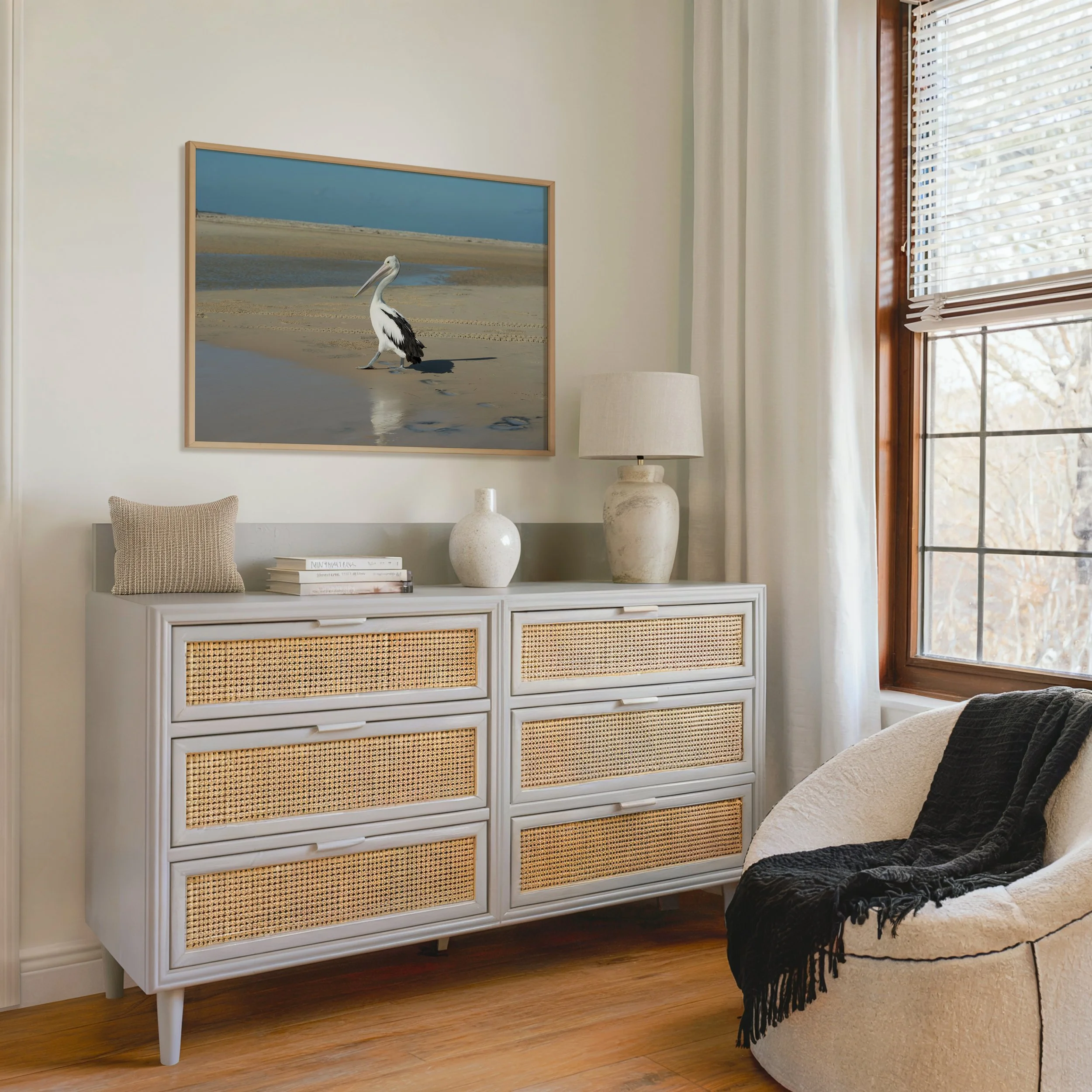 framed pelican print styled above a chest of draws