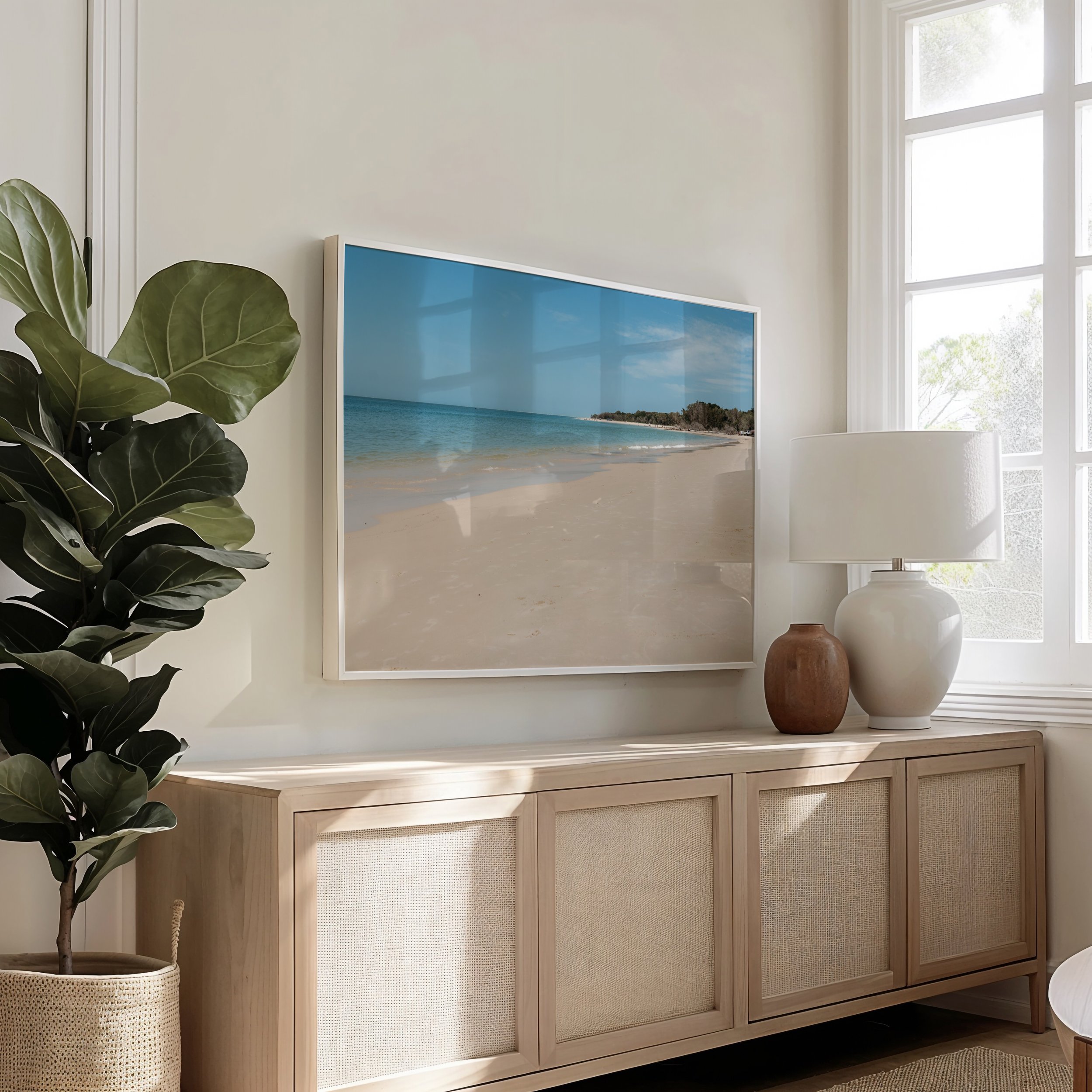 framed coastal beach photograph displayed in a living room setting