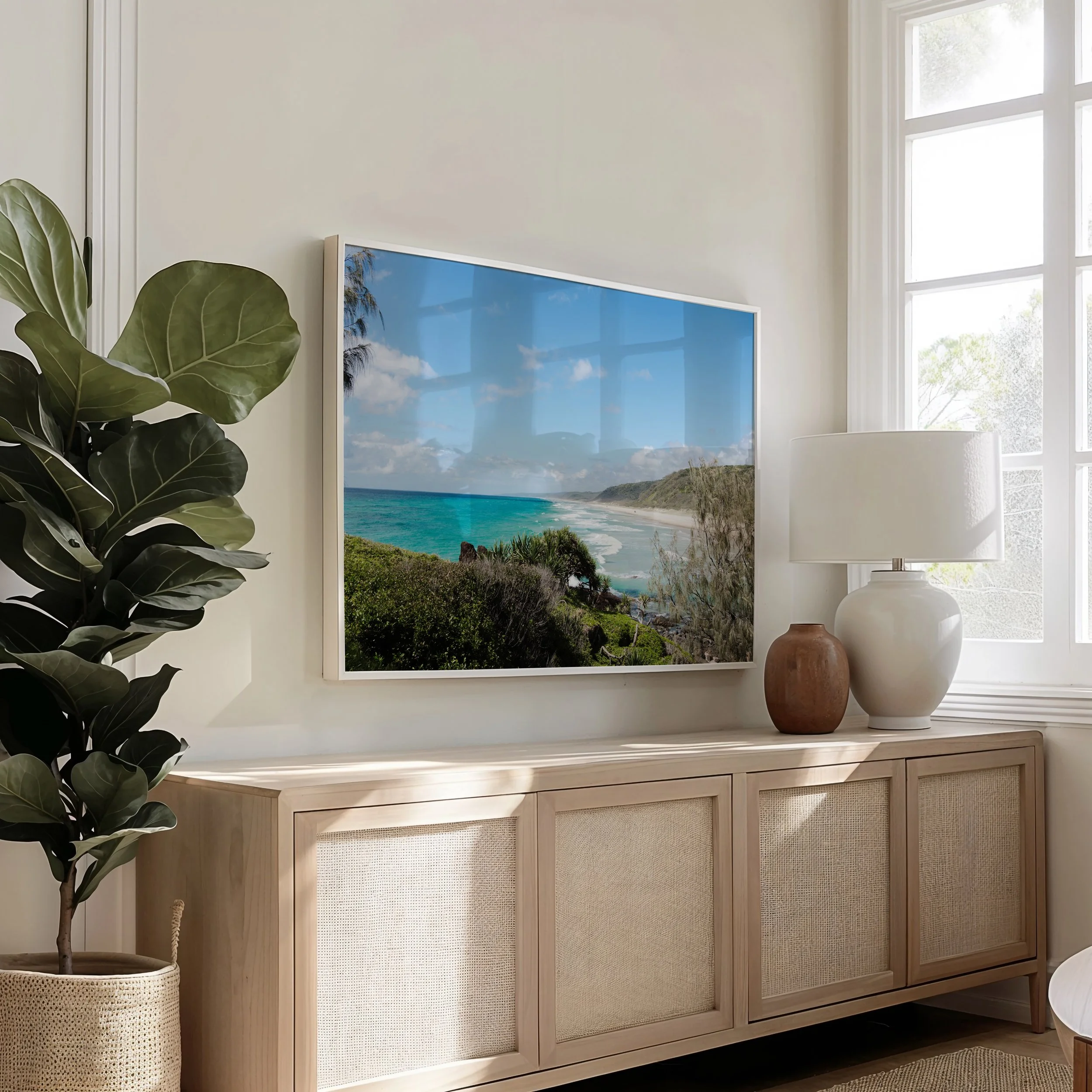 Framed Double Island Point coastal photograph displayed in a living room setting