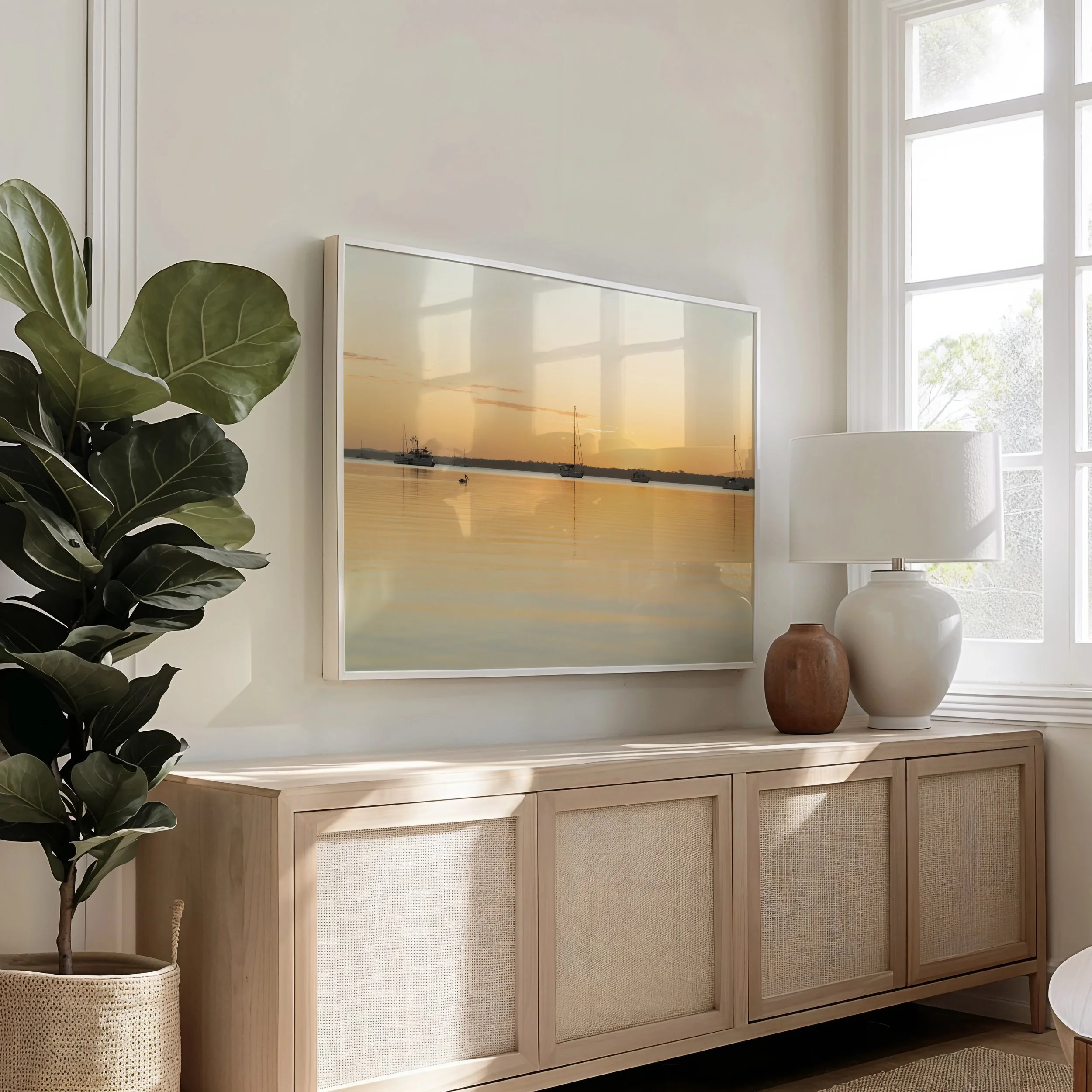 Framed sunset marina photograph displayed in a living room setting