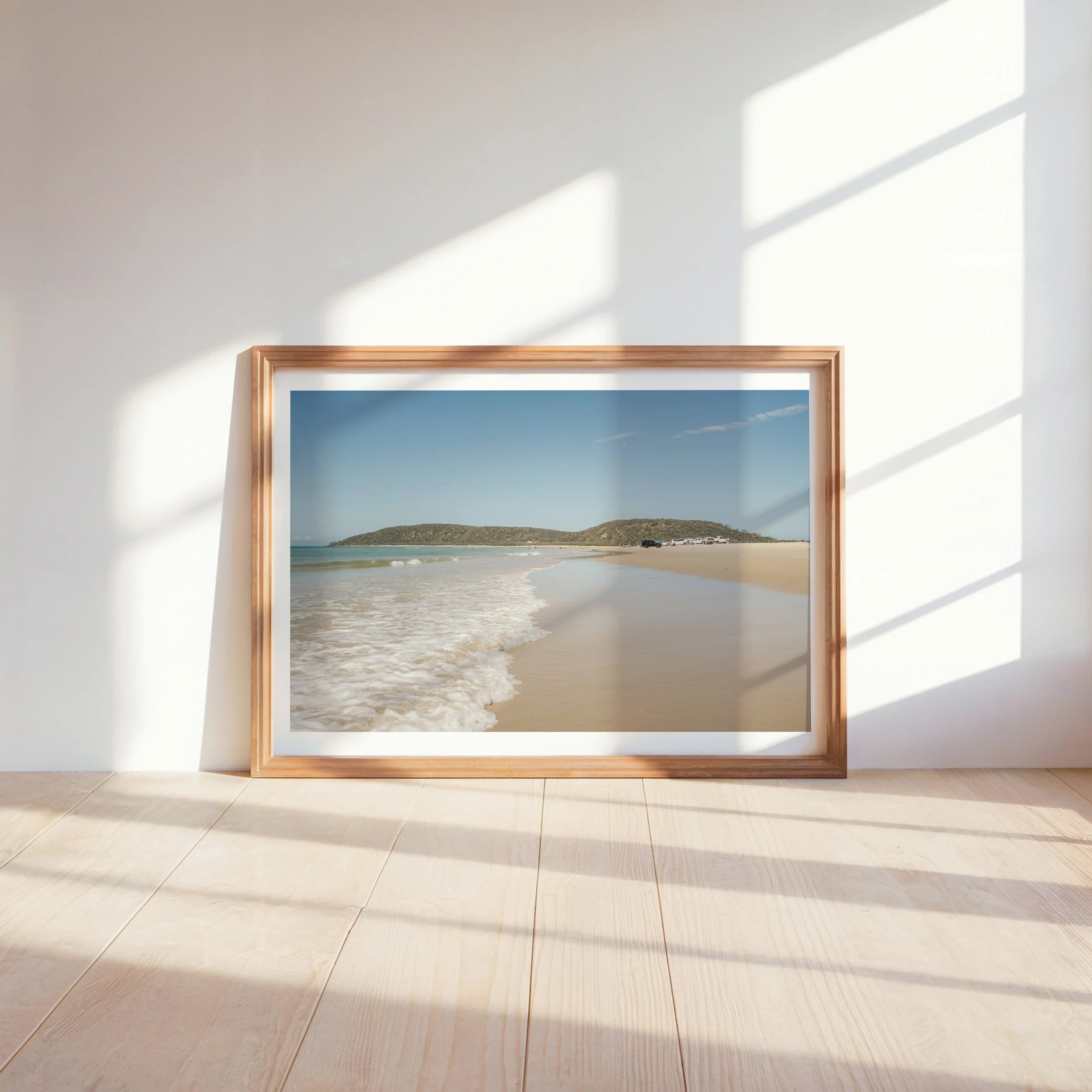 Lifestyle mockup of Lagoon Days Rainbow Beach coastal photograph displayed in a bright, modern interior