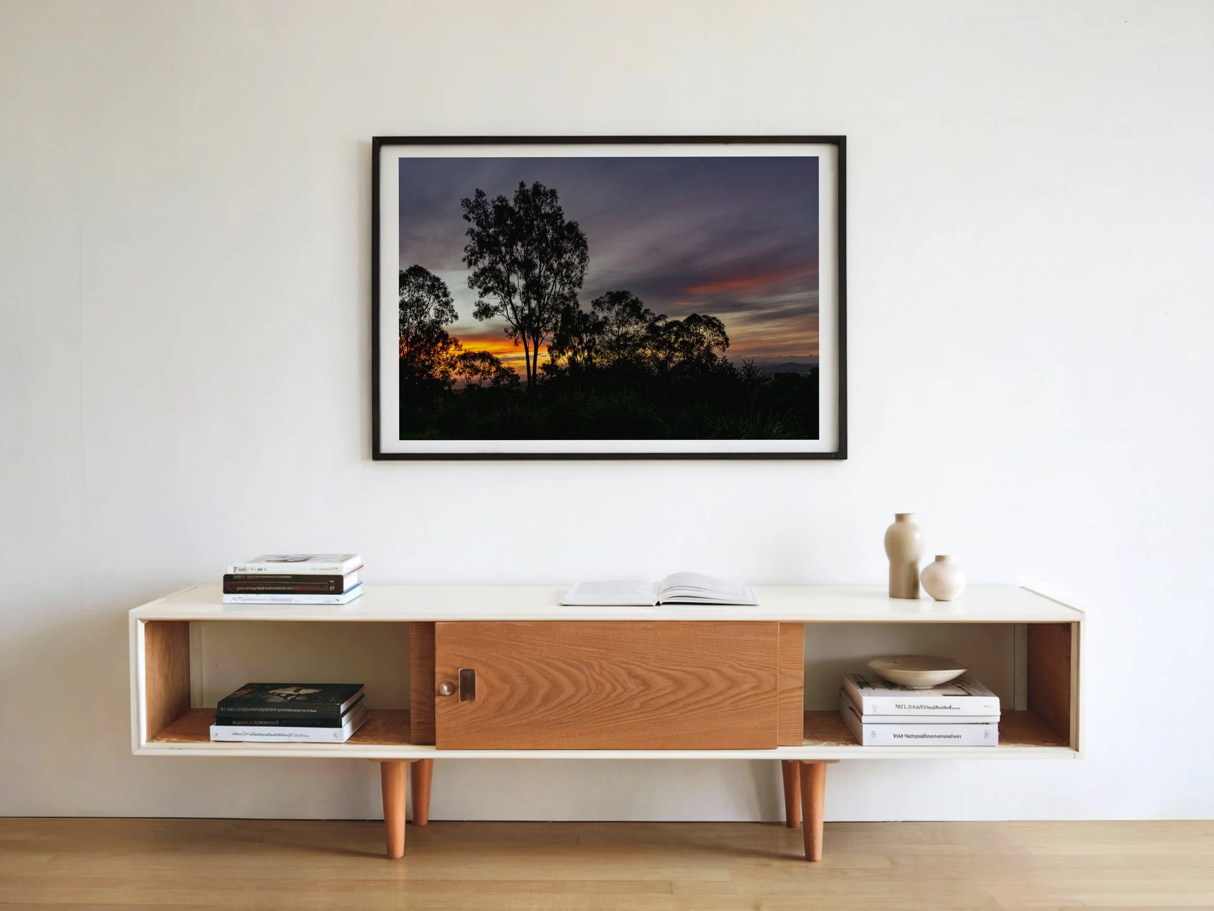 Sunset landscape print styled as wall art in a modern interior