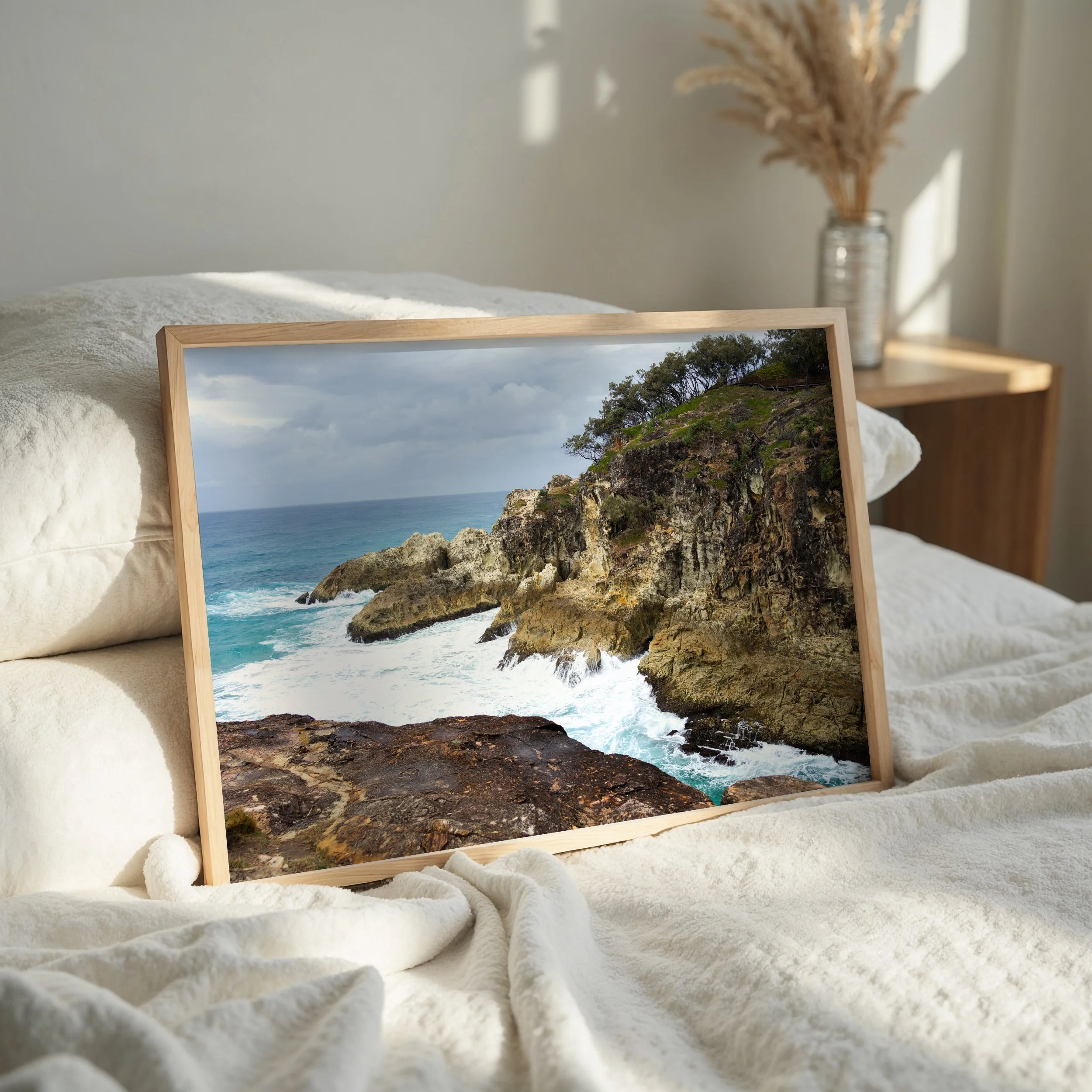 Coastal cliff landscape print styled as wall art in a modern interior