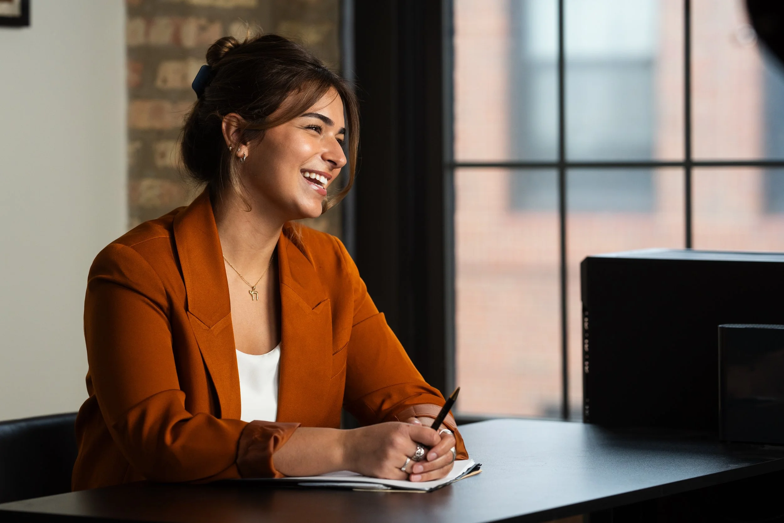 Ilana Foggle, sitting at a desk — ready to dig into a new speechwriting engagement.