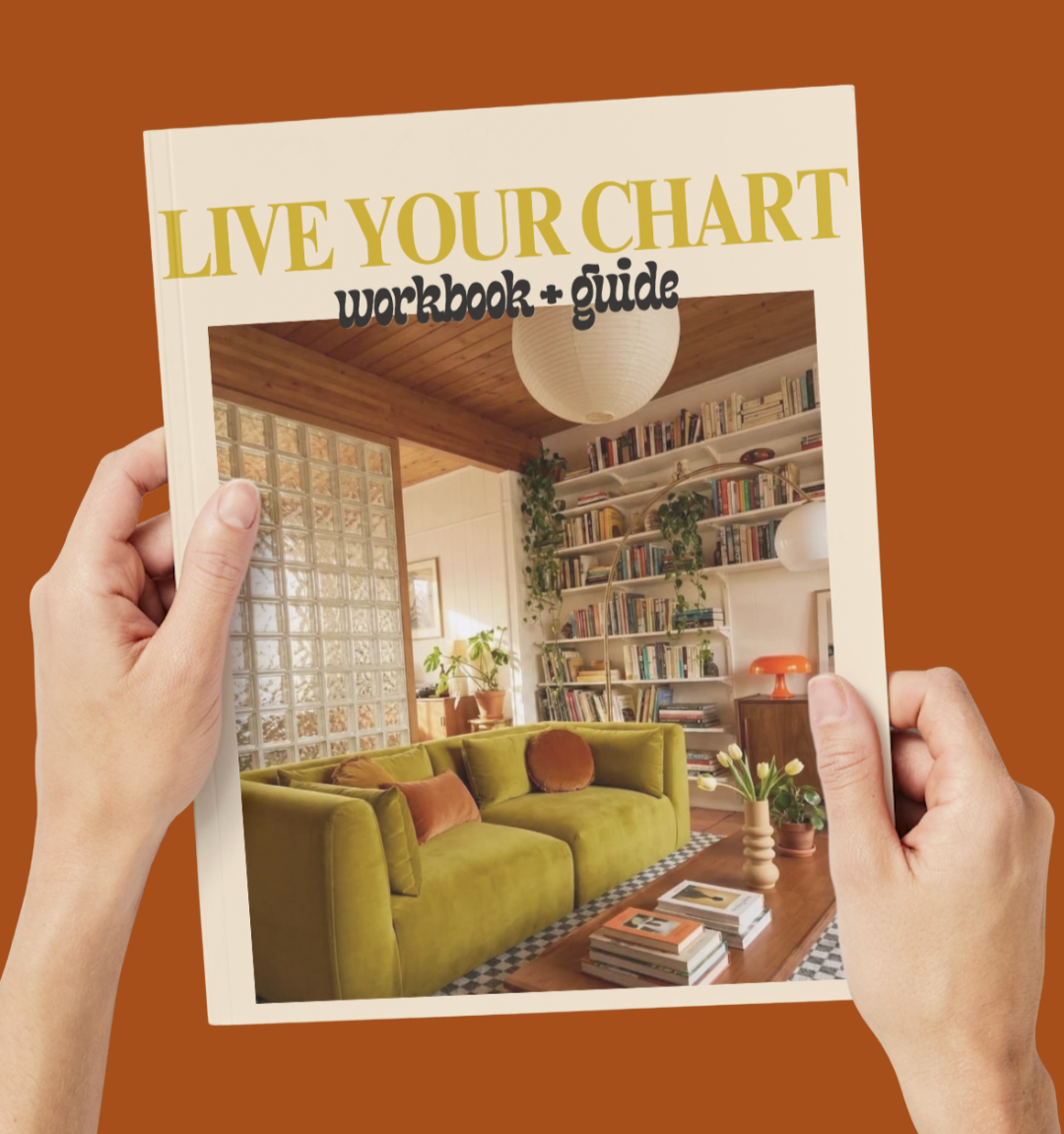Two hands hold up a magazine entitled Live Your Chart Workbook and Guide