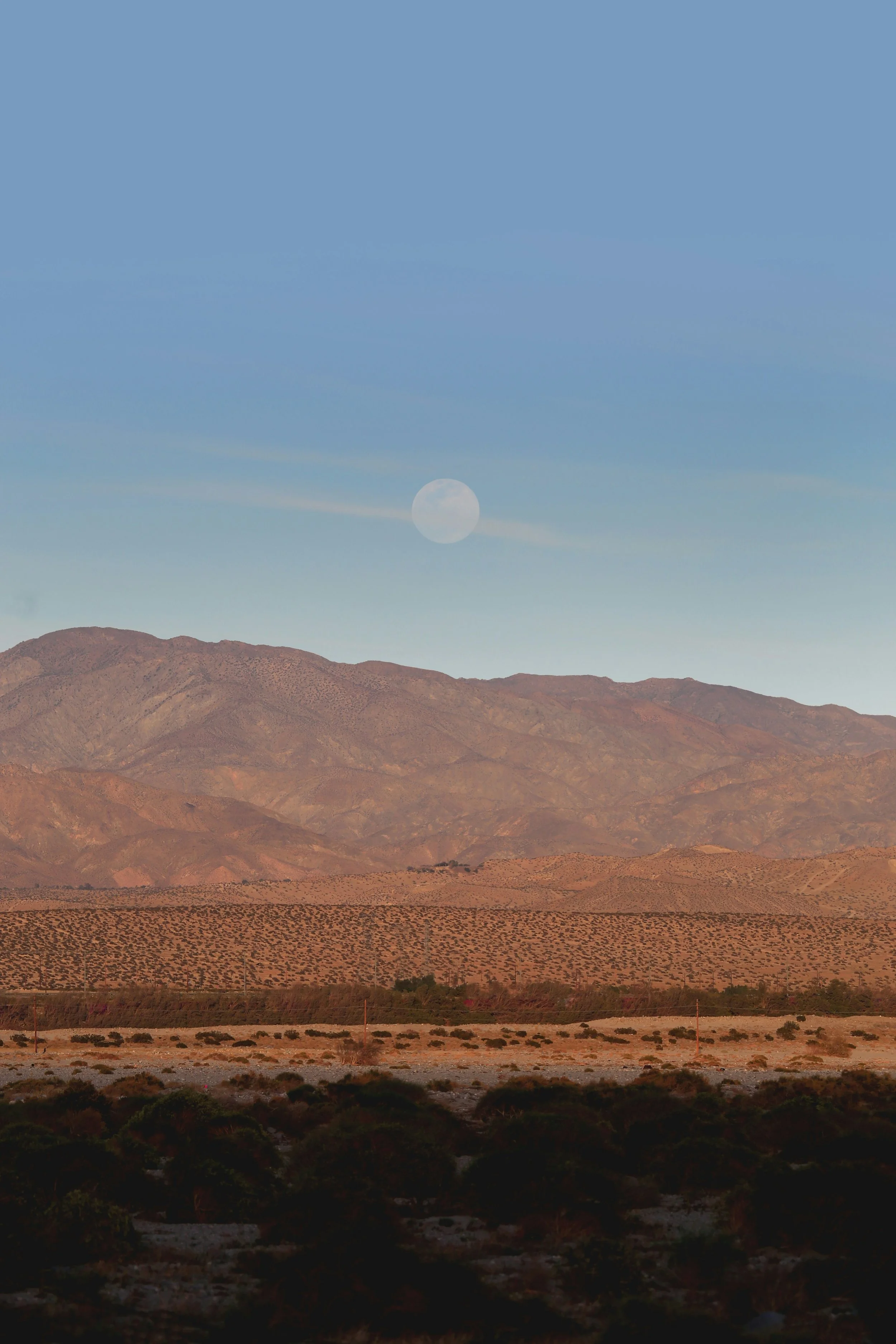 Full Moon above a red mountain