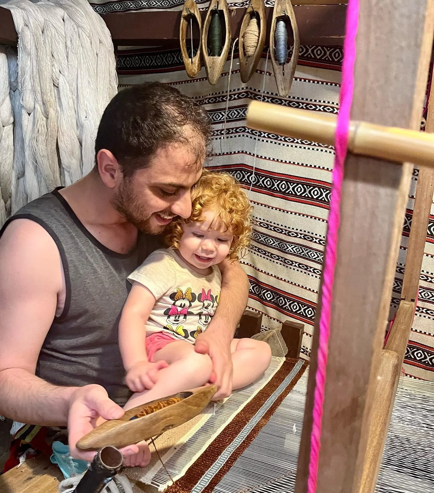 Mila and dad on loom.jpg