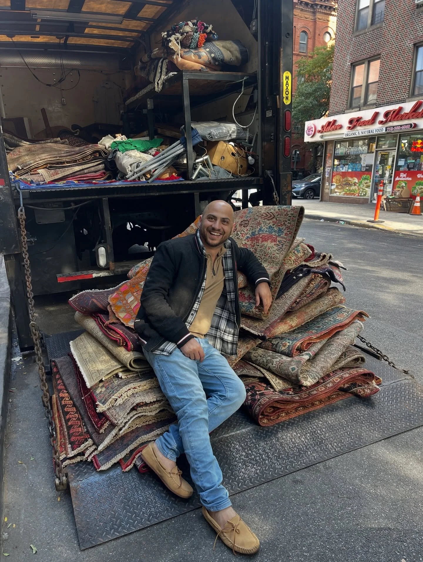 Mahmoud with truck of rugs.jpg