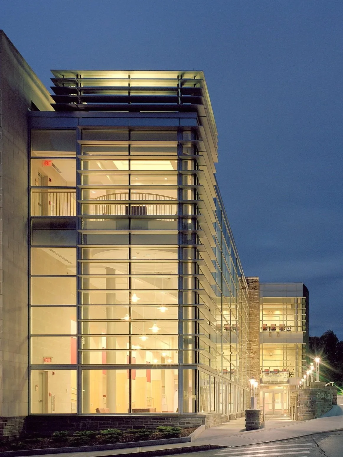 The Beck Center at Cornell University - contemporary multi-story commercial building with glass facade at twilight