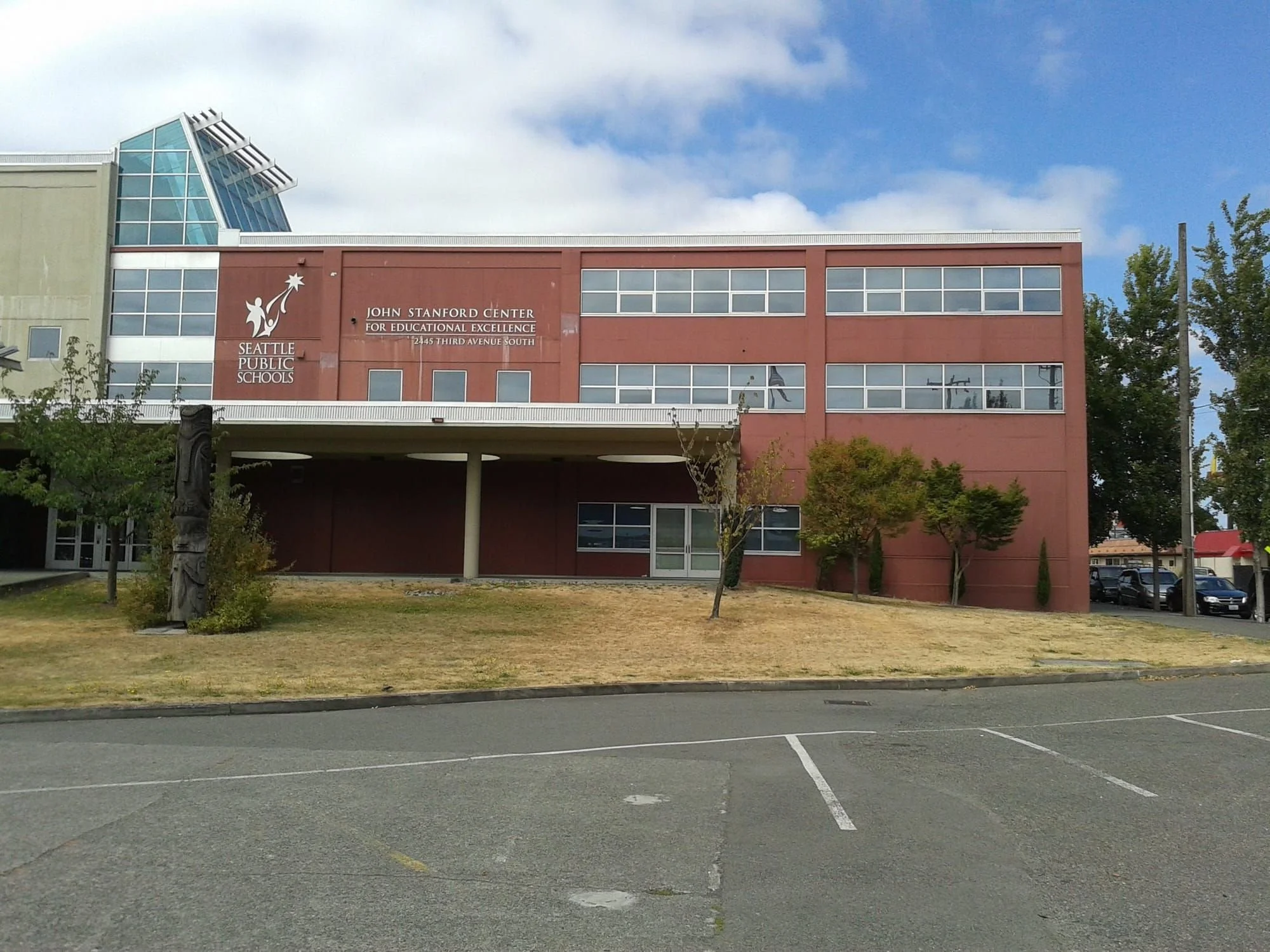 A street-level photo of the front of the JSCEE (John Stanford Center for Educational Excellence), which is where Seattle Public Schools is headquartered.